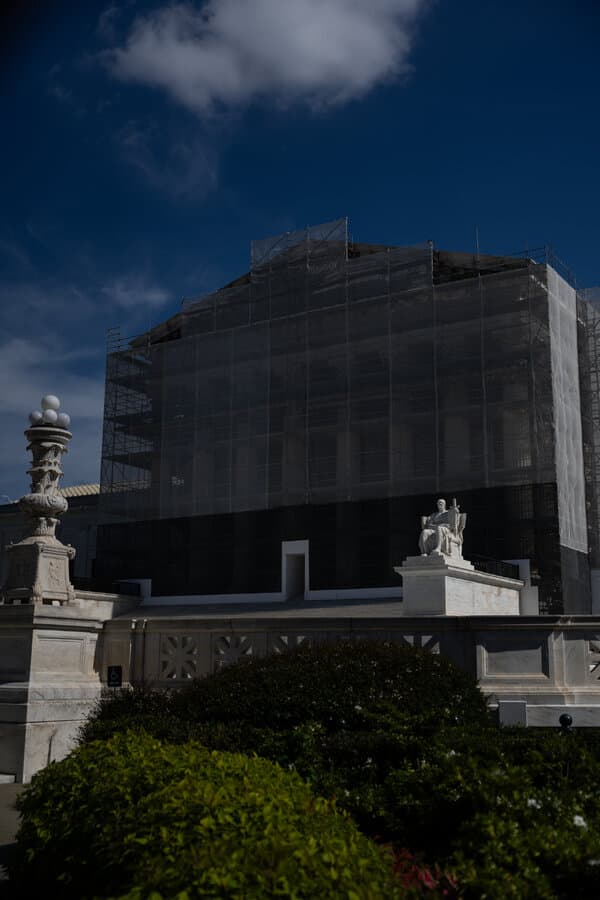 A photo illustration depicting a judge's gavel resting on a stack of gold coins, symbolizing the Supreme Court's alleged bias towards the wealthy.