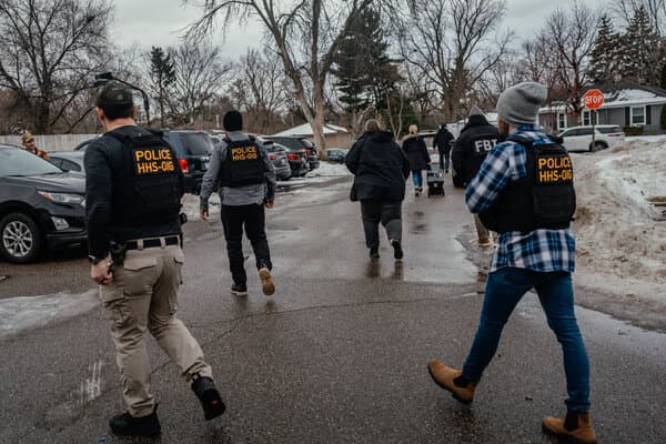 Former President Trump speaking at a podium, with American flags in the background.
