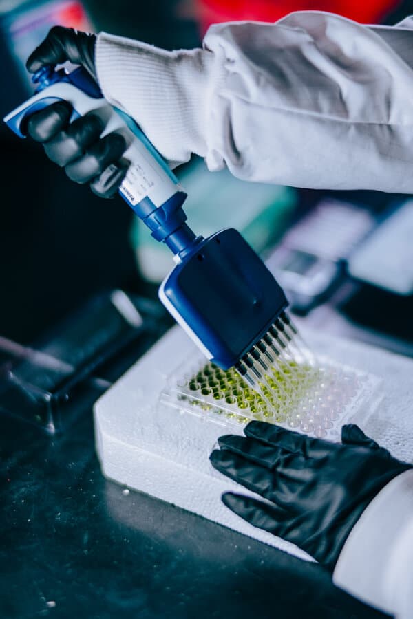 Scientific equipment and medical vials representing the race to market autism biomarker tests.