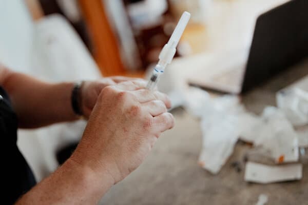 Robert F. Kennedy Jr. speaking at a podium about vaccine policy.