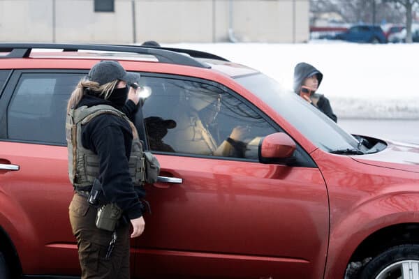 Federal agents conducting an operation in a Minneapolis neighborhood.