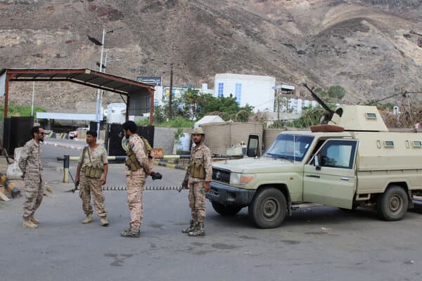 Yemeni separatist fighters standing near a checkpoint in southern Yemen