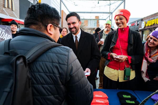 Mamdani handing out free theater tickets to members of the community.