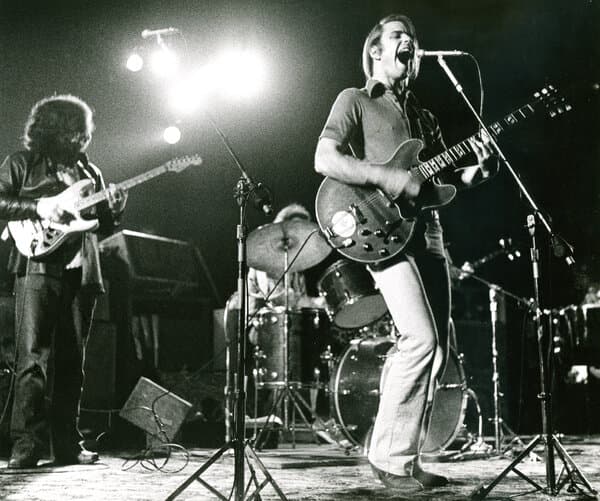 Bob Weir performing on stage with an electric guitar
