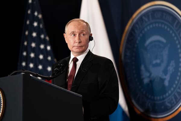 Vladimir Putin in formal attire during diplomatic discussions