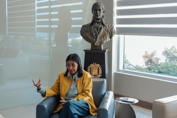 Delcy Rodriguez speaking at a podium during a diplomatic meeting