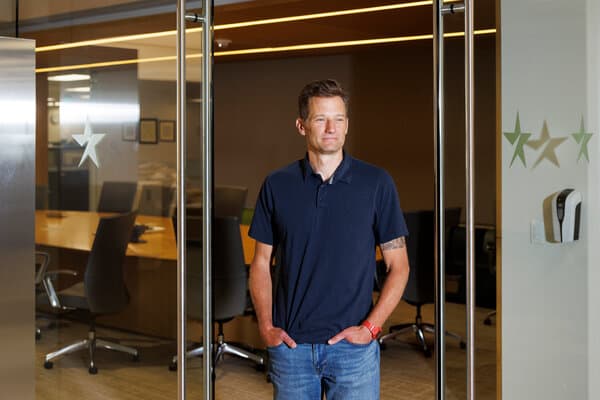 An image depicting the aftermath of the Minneapolis shooting amidst a digital overlay of social media icons, representing the spread of disinformation.