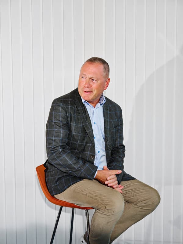 Nicolai Tangen standing in front of a backdrop related to Norges Bank Investment Management