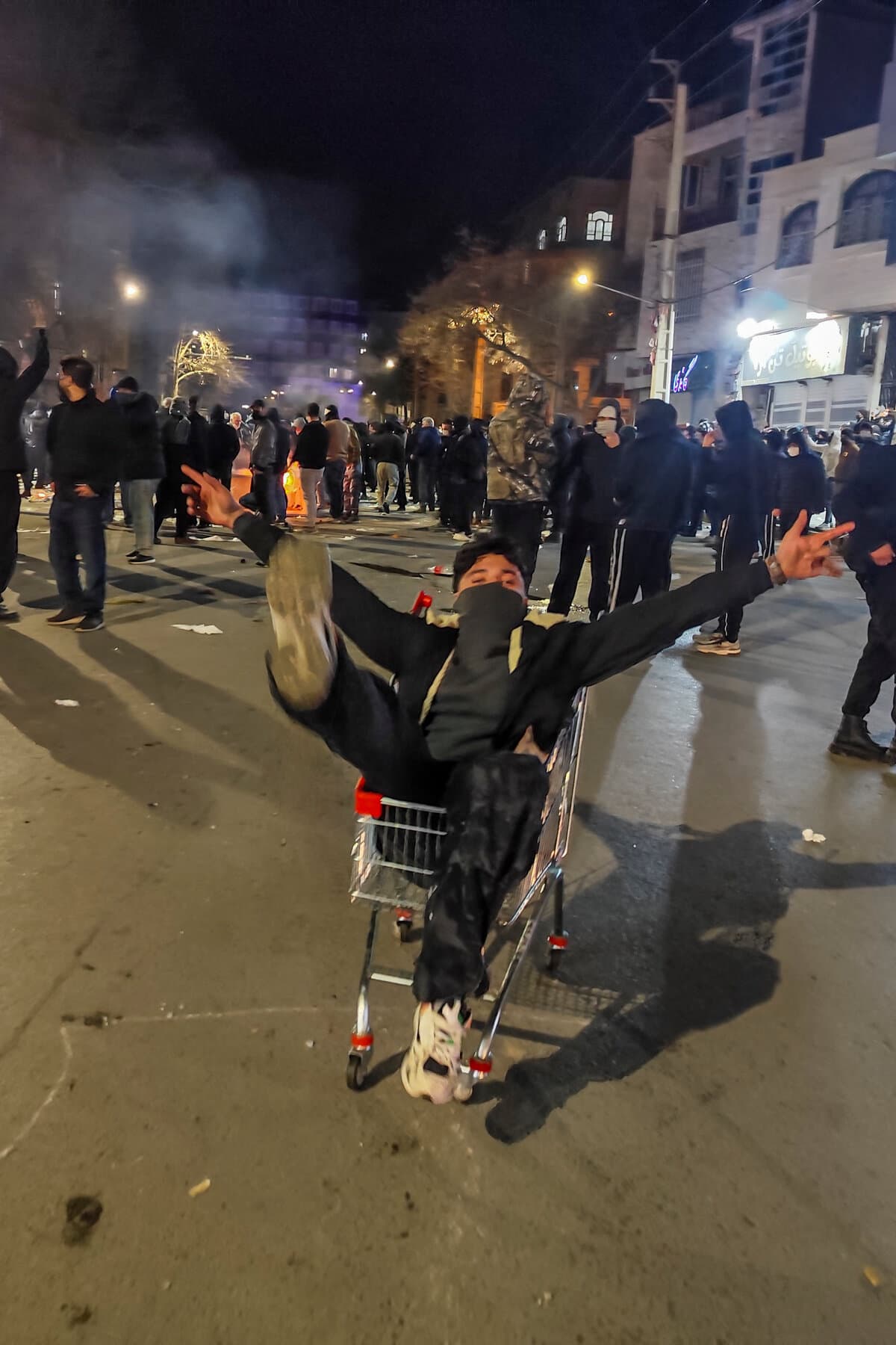 Protesters in Iran holding signs during anti-government demonstrations